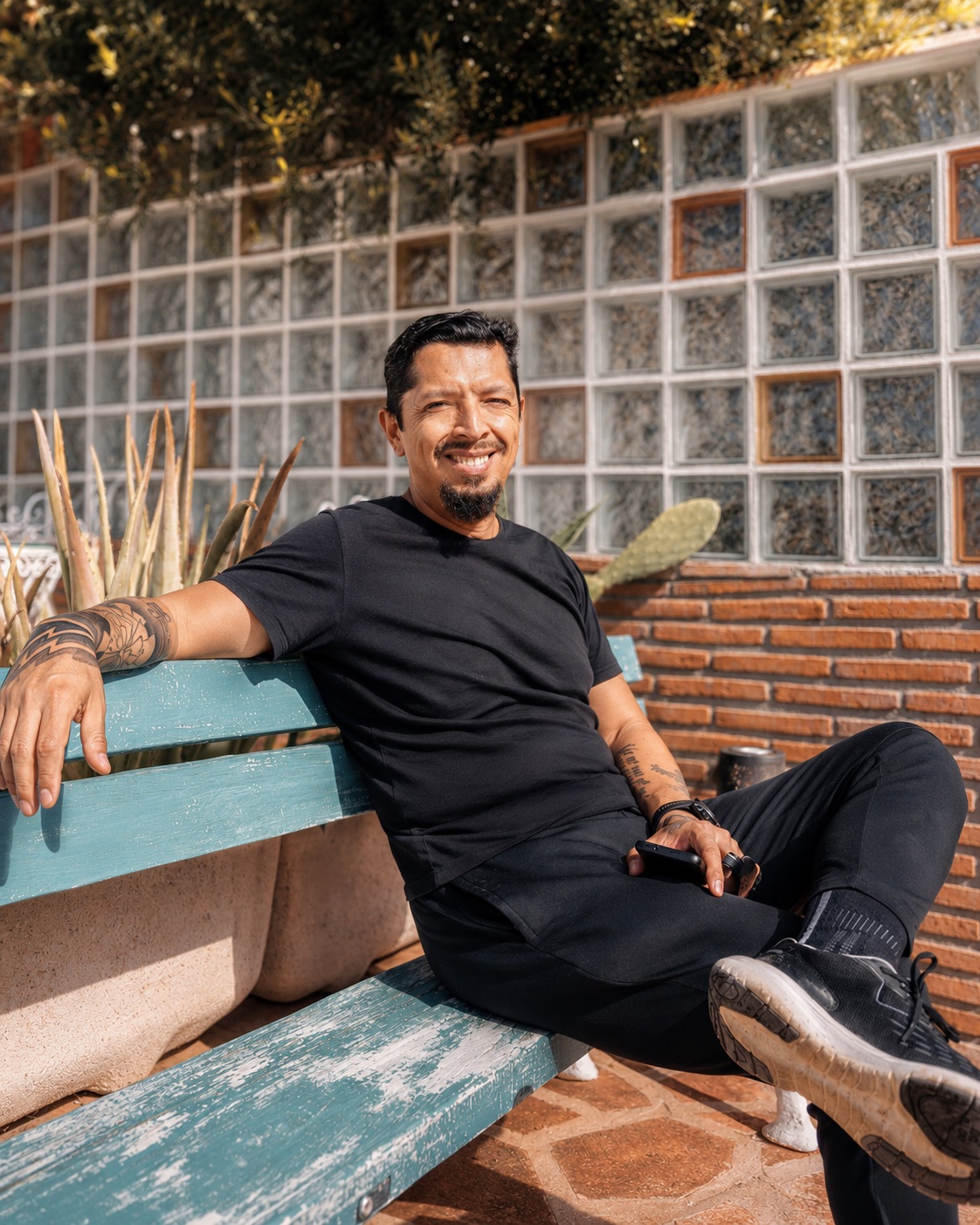 Oscar Trelles seated on a bench, relaxed and approachable